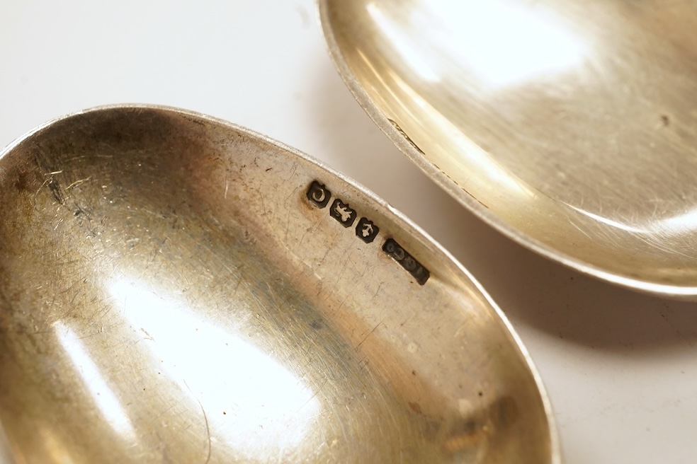 A matched set of six mainly George V silver/white metal and enamel teaspoons, with terminals decorated with dog's heads, 13.6cm. Condition - fair